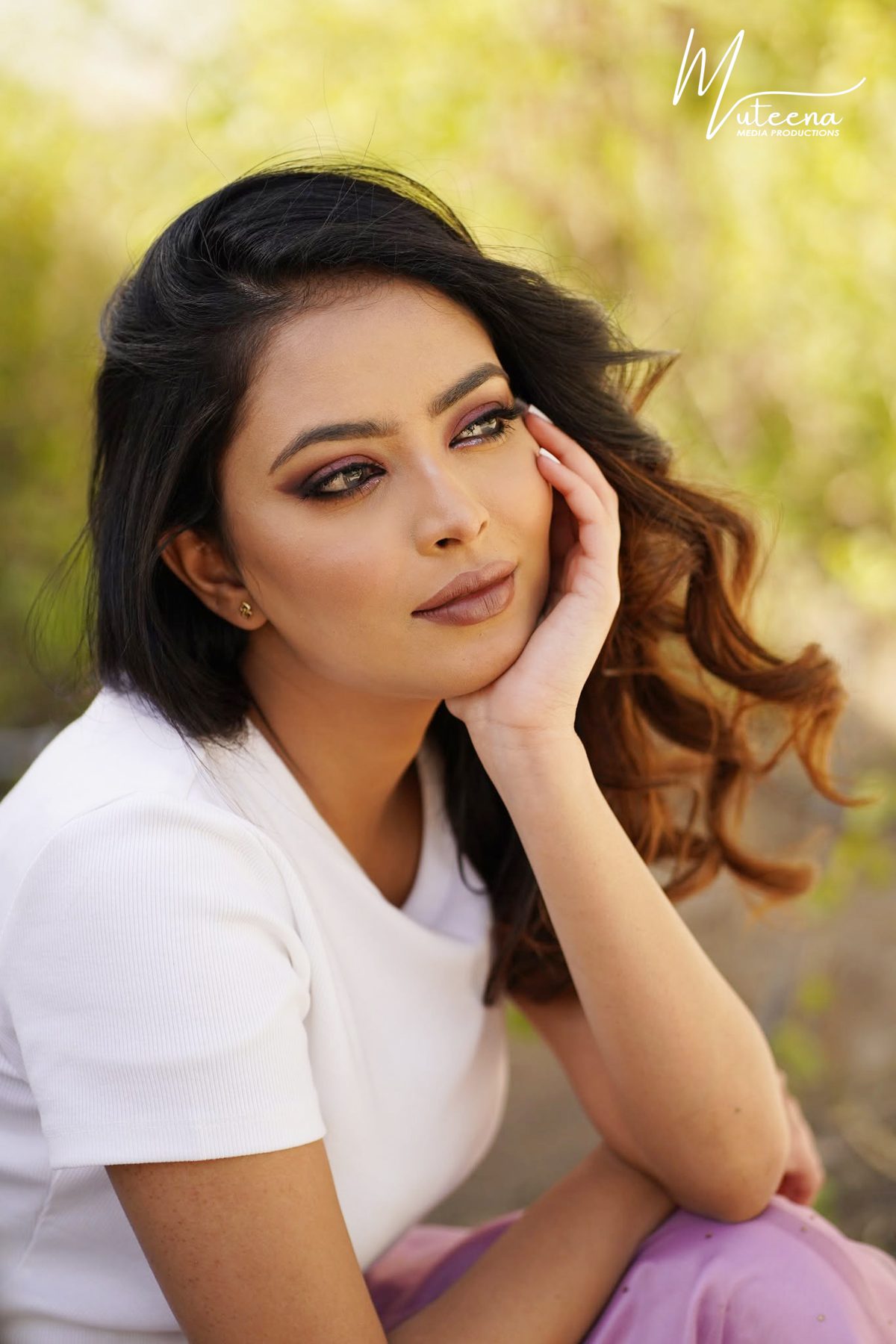 Outdoor beauty portrait of a woman in a white top with soft golden backlight, photographed in Dubai