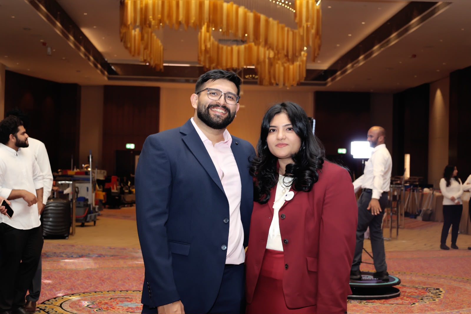 Couple photographed under a gold chandelier at a Dubai ballroom event