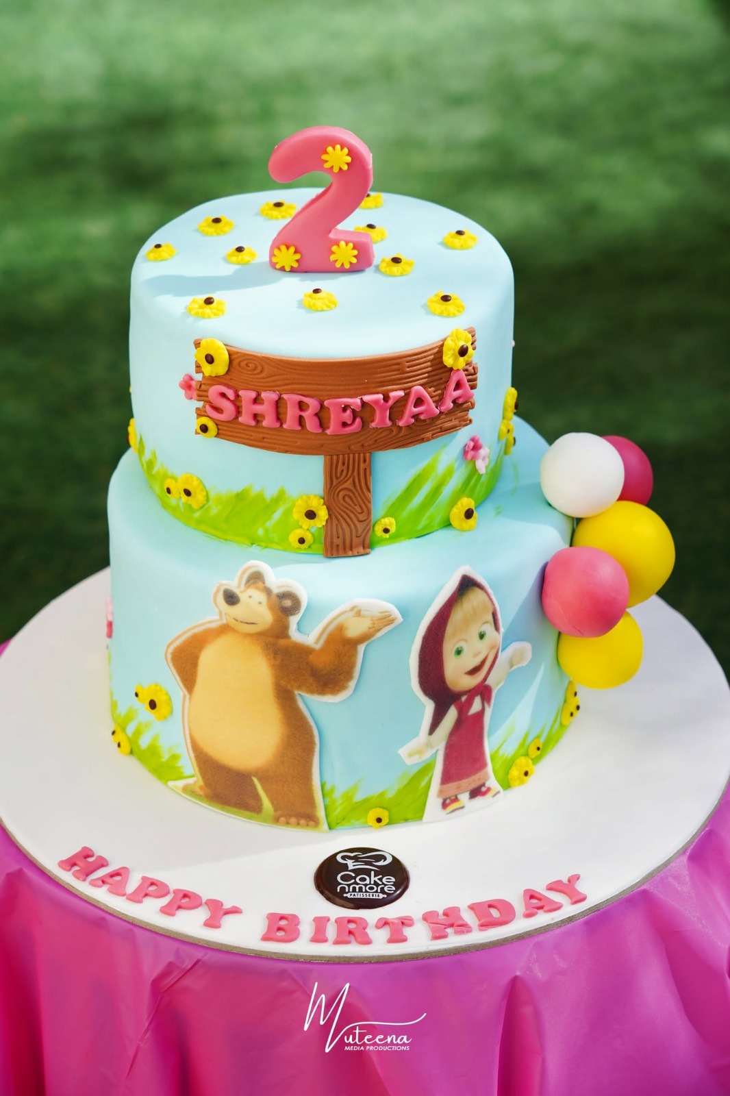 Two-tier Masha and the Bear themed 2nd birthday cake with fondant sunflowers — Dubai cake photography